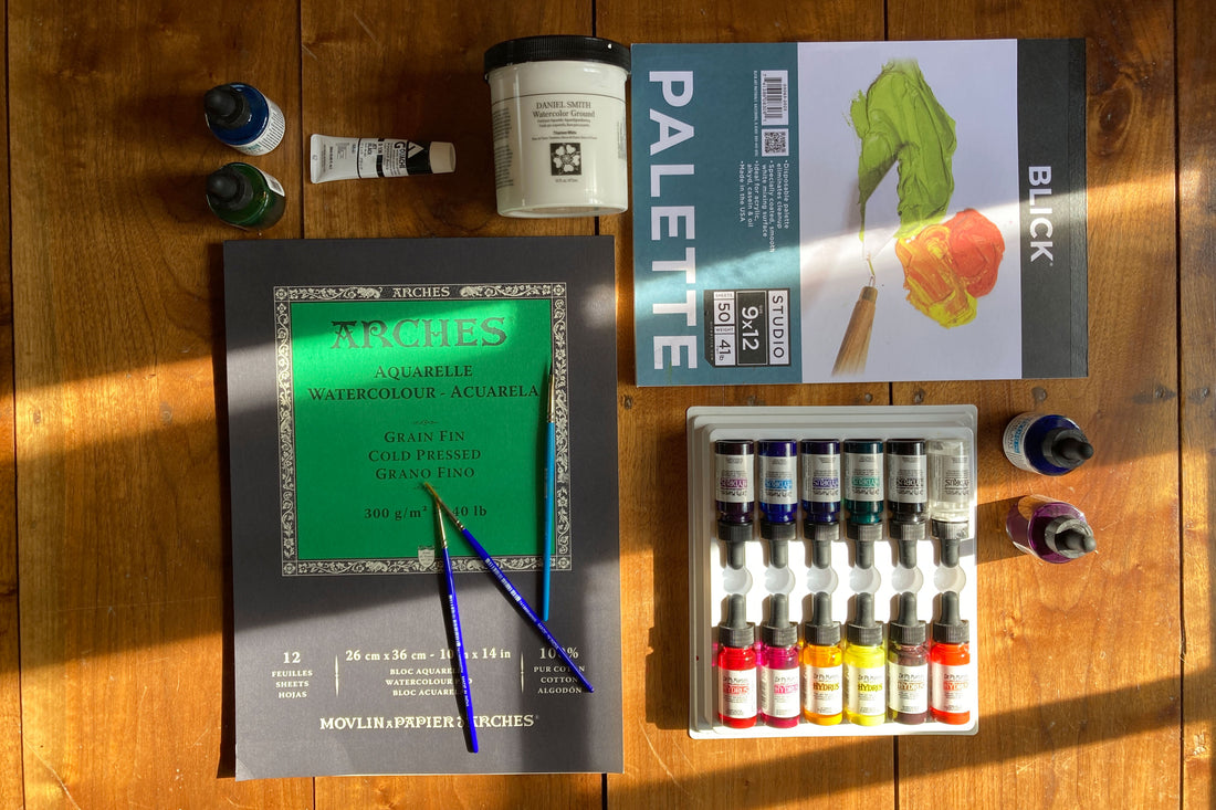 Various art supplies (liqiuid watercolor, brushes, paper, watercolor ground, palette paper)